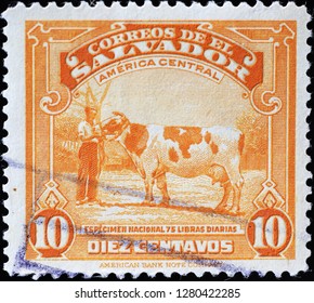 Milan, Italy – December 11, 2018: Farmer And Cow On Vintage Stamp Of El Salvador