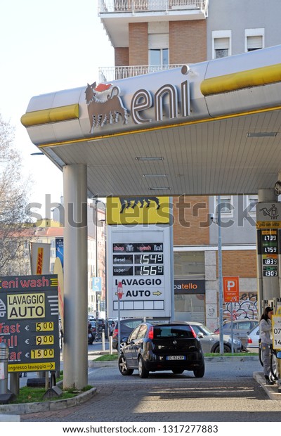 Milan,\
Italy february 19,2019 - Eni petrol station for refueling cars,\
rising costs of green petrol gasoline - gas station in the city\
center in the vicinity of housing , logo and\
sign