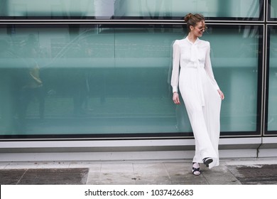Milan, Italy - February 24, 2018: Stylish girl posing for photographers after Armani show during Milan Fashion Show.