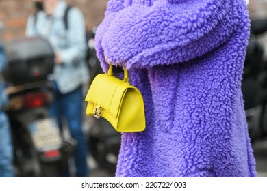 Milan, Italy - February 24, 2022: Street Style, Woman Wearing A Furry Purple Coat, Yellow Bag And Purple Sandals.