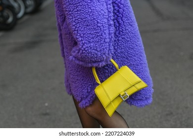 Milan, Italy - February 24, 2022: Street Style, Woman Wearing A Furry Purple Coat, Yellow Bag And Purple Sandals..