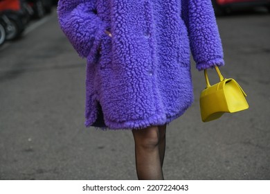 Milan, Italy - February 24, 2022: Street Style, Woman Wearing A Furry Purple Coat, Yellow Bag And Purple Sandals..