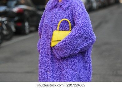 Milan, Italy - February 24, 2022: Street Style, Woman Wearing A Furry Purple Coat, Yellow Bag And Purple Sandals.