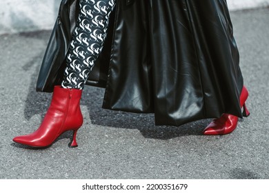 MILAN, ITALY - FEBRUARY 24: Street Style Outfit - Woman Wearing Black Leather Skirt And Red Shoes.