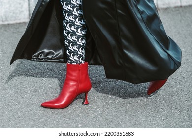 MILAN, ITALY - FEBRUARY 24: Street Style Outfit - Woman Wearing Black Leather Skirt And Red Shoes.