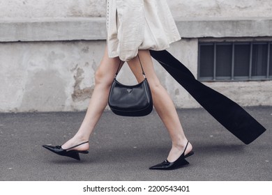 Milan, Italy - February, 24: Street Style, Woman Wearing Cream Leather Jacket, Mini Skirt With Long Train, Black Prada Bag And Prada Heels.