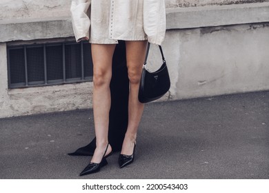 Milan, Italy - February, 24: Street Style, Woman Wearing Cream Leather Jacket, Mini Skirt With Long Train, Black Prada Bag And Prada Heels.