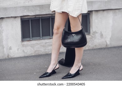 Milan, Italy - February, 24: Street Style, Woman Wearing Cream Leather Jacket, Mini Skirt With Long Train, Black Prada Bag And Prada Heels.