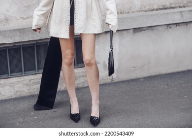 Milan, Italy - February, 24: Street Style, Woman Wearing Cream Leather Jacket, Mini Skirt With Long Train, Black Prada Bag And Prada Heels.