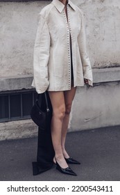 Milan, Italy - February, 24: Street Style, Woman Wearing Cream Leather Jacket, Mini Skirt With Long Train, Black Prada Bag And Prada Heels.