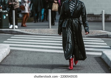 MILAN, ITALY - FEBRUARY 24: Street Style Outfit - Woman Wearing Black Leather Skirt And Red Shoes.