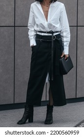 Milan, Italy - February, 24: Street Style, Woman Wearing White V-neck Shirt And Black Leather Pants.