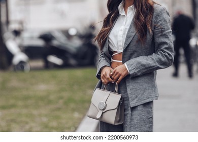 Milan, Italy - February, 24: Street Style, Woman Wearing White Cropped Shirt, A Gray Blazer Jacket, Gray Matching Suit Pants, A Beige Leather Handbag And Yellow Green Open Toe-cap Pumps Sandals.