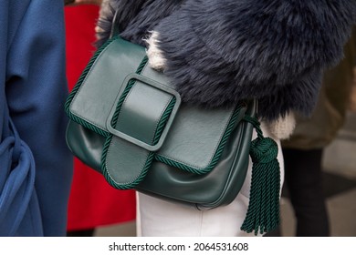 MILAN, ITALY - JANUARY 14, 2019: Woman With Green Leather Bag And Gray Fur Coat, Street Style