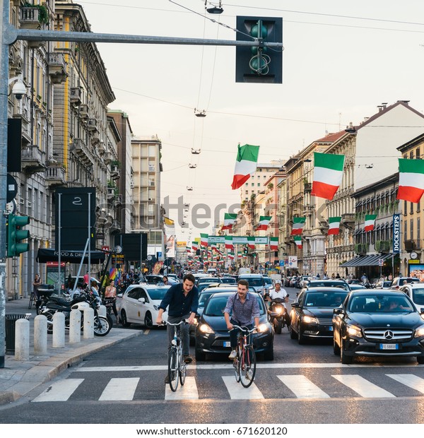 Milan, Italy - July 4th, 2017: Italian flags line\
up on Corso Buenos Aires street Milan Lombardy region Italy Europe,\
a busy shopping street