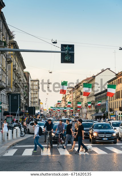 Milan, Italy - July 4th, 2017: Italian flags line\
up on Corso Buenos Aires street Milan Lombardy region Italy Europe,\
a busy shopping street