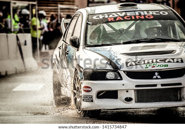 Milan, Italy, June 02, 2018: a white Mitsubishi\
Lancer Evolution in action during a rally race on asphalt at the\
Iper Drive in Milan.