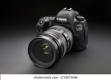 Milan, Italy - June 11, 2020: close up on a Canon EOS 5D Mark IV with EF24-70mm f/2.8 L USM lens, resting on a black background.
