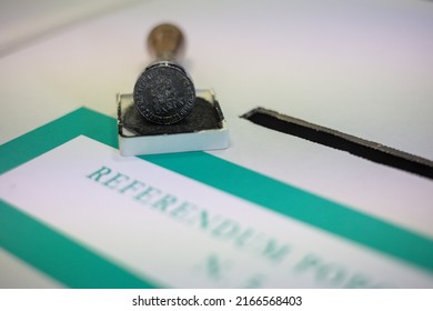 Milan, Italy - June 12, 2022: Italian Election Day Of June 12, 2022, Five Italian Referendums On The Judicial System. A Hand Inserts A Ballot Into The Ballot Box