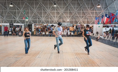 MILAN, ITALY - JUNE 22: People dance at Rocking The Park, event dedicated to American music and lifestyle of the 40s, 50s and 60s on JUNE 22, 2014 in Milan.