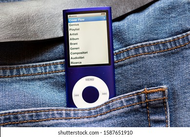 MILAN, ITALY – June 4, 2019: Apple IPod Nano 8Gb, Blue Music Player In The Jeans Pocket Background. The Device Screen Is Showing A Music Playlist
