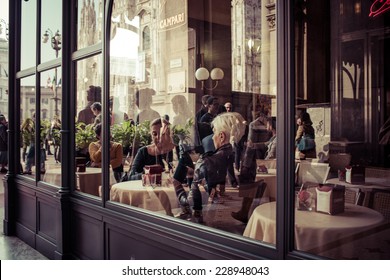 MILAN, ITALY - MARCH 5, 2014: People eating at small cafe at Galleria Vittorio Emanuele II shopping mall in Milan. Toned picture