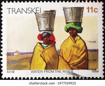 Milan, Italy - May 08, 2021: African Women Carrying Water On Postage Stamp