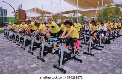 Milan, Italy - May 1, 2015: Mixed Group Riding Bikes In Spinning Class Outdoor