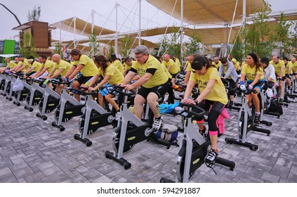 Milan, Italy - May 1, 2015: Mixed Group Riding Bikes In Spinning Class Outdoor