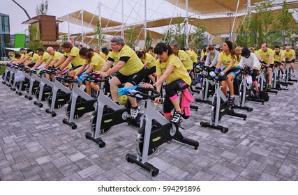 Milan, Italy - May 1, 2015: Mixed Group Riding Bikes In Spinning Class Outdoor