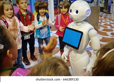 Milan, Italy - May 22, 2017: A Group Of Children Together With A Pepper Robot