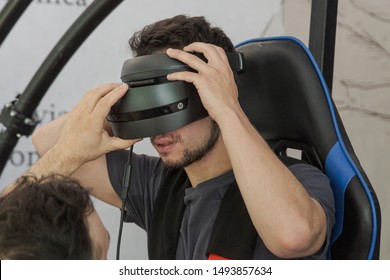MILAN, ITALY - MAY 24: Guy tries virtual reality space dive machine at Wired Next Fest, event dedicated to future, innovation and creativity on MAY 24, 2019 in Milan.