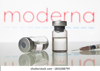 Milan, Italy: November 14, 2020: Vials and syringe with Moderna Inc logo. Big Pharma companies are completing clinical trials to get the approval for a vaccine to fight the coronavirus Covid-19 virus