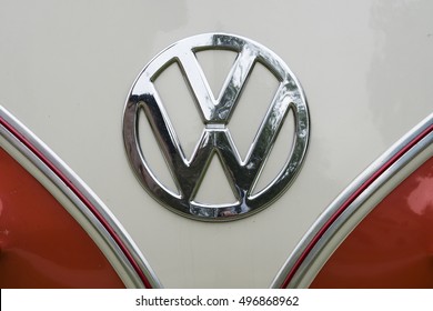 MILAN / ITALY - OCTOBER 01, 2016: Detail of a red and white 1960s VW campervan with the iconic volkswagen badge.