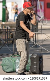 MILAN, ITALY - SEP 24, 2016: A boy beatbox performs in a street of the city center of Milan. The beatboxing is a form of vocal percussion using mouth, lips, tongue and voice