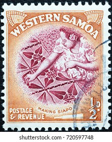 Milan, Italy - September 1, 2017: Samoan Woman Making A Cloth On Old Stamp