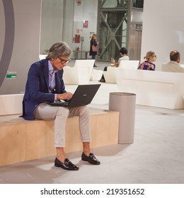 MILAN, ITALY - SEPTEMBER 13: Stylish man working at computer at HOMI, home international show and point of reference for all those in the sector of interior design on SEPTEMBER 13, 2014 in Milan. - Shutterstock ID 219351652