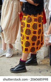 MILAN, ITALY - SEPTEMBER 18, 2019: Woman With Yellow Skirt And Black Dr Martens Boots, Street Style 