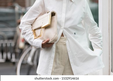 Milan, Italy - September 19, 2019: model wears a pair of beige linen trousers and a white shirt during the Armani show for the spring / summer 2020 collection