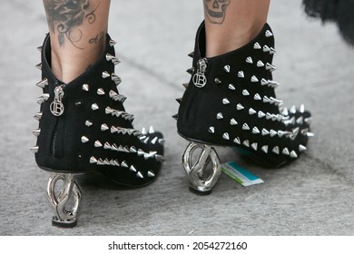 MILAN, ITALY - SEPTEMBER 19, 2019: Woman with black Laura Biagiotti shoes with silver studs and heel, street style 