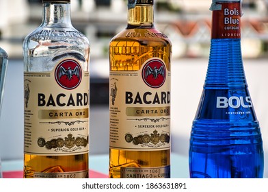 Milan, Italy, September 19, 2020: Closeup Of Two Bottles Of Bacardi Gold Rum And A Bottle Of Bols Curacao Blue Liquer