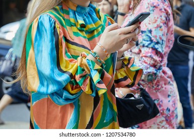 MILAN, ITALY - SEPTEMBER 20, 2018: Woman With Colorful Dress Looking At Phone Before Max Mara Fashion Show, Milan Fashion Week Street Style