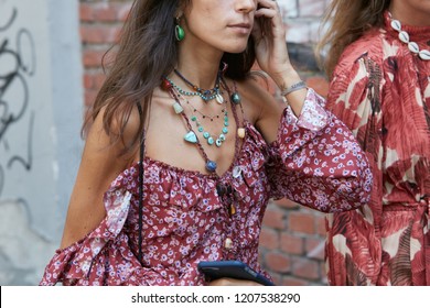 MILAN, ITALY - SEPTEMBER 20, 2018: Woman With Red And Pink Floral Dress And Colorful Stones Necklace Before Fendi Fashion Show, Milan Fashion Week Street Style