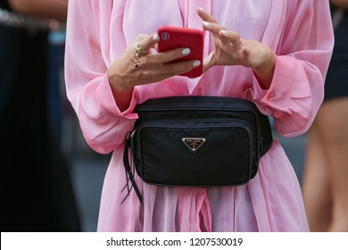 MILAN, ITALY - SEPTEMBER 21, 2018: Woman With Pink Dress And Black Prada Pouch Before Marco De Vincenzo Fashion Show, Milan Fashion Week Street Style