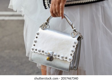 MILAN, ITALY - SEPTEMBER 21, 2019: Woman With Silver Leather Fendi Bag And White Skirt, Street Style 