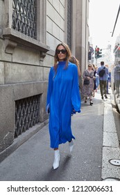 MILAN, ITALY - SEPTEMBER 22, 2018: Woman With Long, Blue Dress And White Pointed Shoes Walking Before Ermanno Scervino Fashion Show, Milan Fashion Week Street Style