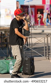 MILAN, ITALY - SEPTEMBER 24, 2016: A boy beatbox performs in a street of the city center of Milan. The beatboxing is a form of vocal percussion using mouth, lips, tongue and voice