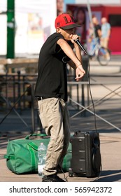 MILAN, ITALY - SEPTEMBER 24, 2016: A boy beatbox performs in a street of the city center of Milan. The beatboxing is a form of vocal percussion using mouth, lips, tongue and voice