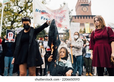 MILAN, ITALY - SEPTEMBER 25, 2022: Protestors Demonstrating At Castello Sforzesco In Milan, Italy, Following The Death Of Mahsa Amini Burning Scarf