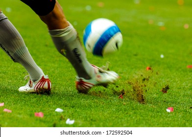 MILAN, ITALY - SEPTEMBER 29: Italian Professional Serie A Soccer Match In Milan September 29, 2006. A Football Player Close Up Kicking The Ball With The Green Pitch On The Background.